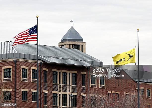 Flags wave in front of the Sprint Nextel operational headquarters after Dish Network made a $25.5 billion bid for the company on April 15, 2013 in...
