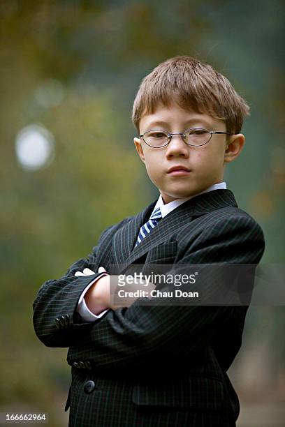 Portrait of a Vietnamese American boy in full suit. MODEL RELEASED.