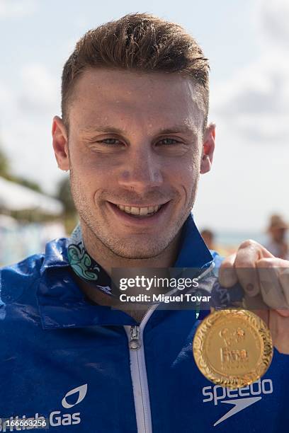 Daniel Fogg of UK pose with the gold medal in the Men's Open Water 10km FINA World Championships at Cozumel Beach on April 13, 2013 in Cozumel,...