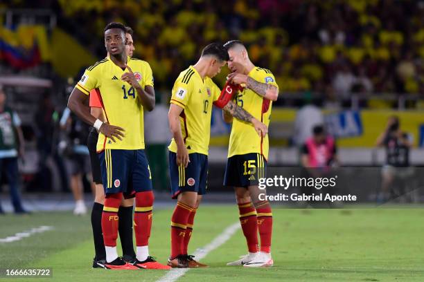 James Rodriguez of Colombia receives the captain's armband from Matheus Uribe of Colombia uring a FIFA World Cup 2026 Qualifier match between...