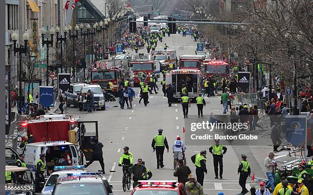 Emergency personnel respond to the scene after two explosions went off near the finish line of the 117th Boston Marathon on April 15, 2013.