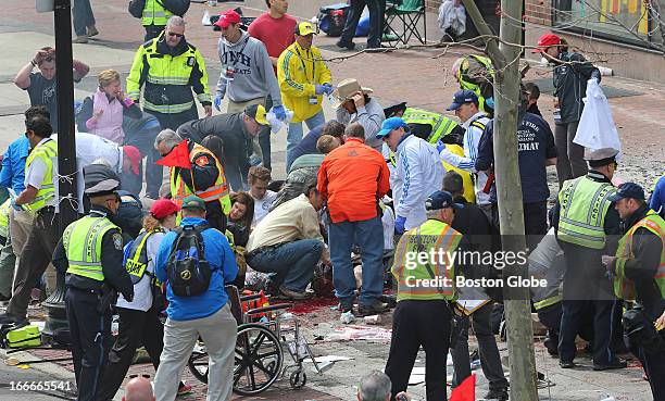 Emergency personnel respond to the scene after two explosions went off near the finish line of the 117th Boston Marathon on April 15, 2013.
