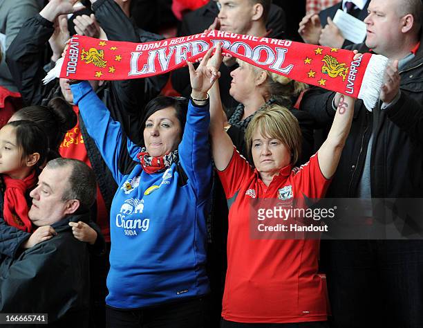 In this handout image provided by Liverpool FC, Everton and Liverpool supporters hold team scarves aloft during the 24th Hillsborough Anniversary...