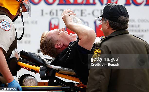 Man is loaded into an ambulance after he was injured by one of two bombs exploded during the 117th Boston Marathon near Copley Square on April 15,...