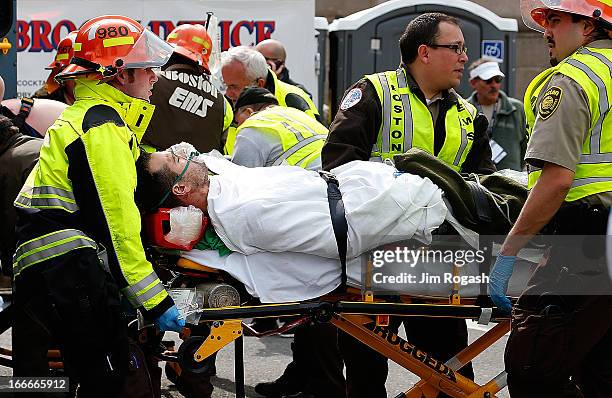 Man is loaded into an ambulance after he was injured by one of two bombs exploded during the 117th Boston Marathon near Copley Square on April 15,...