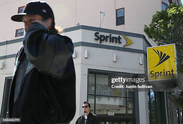 Pedestrians walk by a Sprint store on April 15, 2013 in San Francisco, California. Dish Network Corp has offered to purchase Sprint Nextel Corp for...