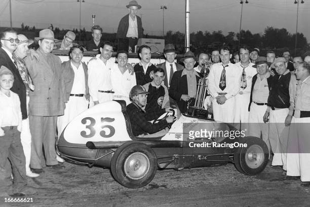 Late-1940s: Ronney Householder attracts a crowd after winning a Midget car race at South Bend Motor Speedway. Householder was the 1935 Detroit...