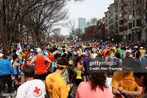 Runners gather near Kenmore Square after two bombs exploded during the 117th Boston Marathon on April 15, 2013 in Boston, Massachusetts. Two people...