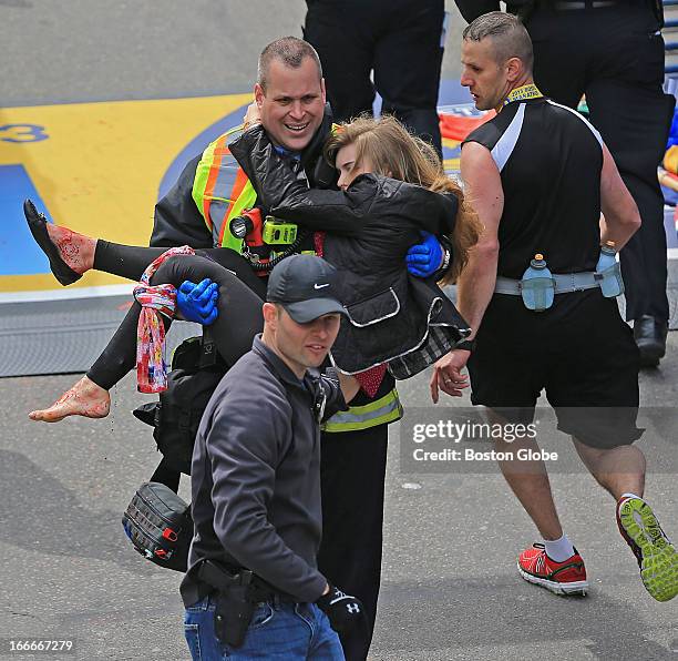 Emergency personnel respond to the scene after two explosions went off near the finish line of the 117th Boston Marathon on April 15, 2013. Victim...