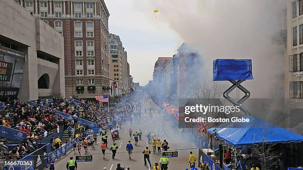 Emergency personnel respond to the scene after two explosions went off near the finish line of the 117th Boston Marathon on April 15, 2013.