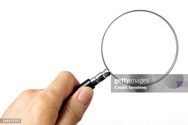 isolated shot of holding a magnifying glass on white background - vergrootglas stockfoto's en -beelden