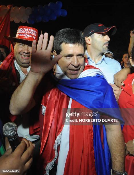 Paraguayan presidential candidate for the Colorado party, Horacio Cartes, waves during a rally in Limpio, in the outskirts of Asuncion on April 15,...