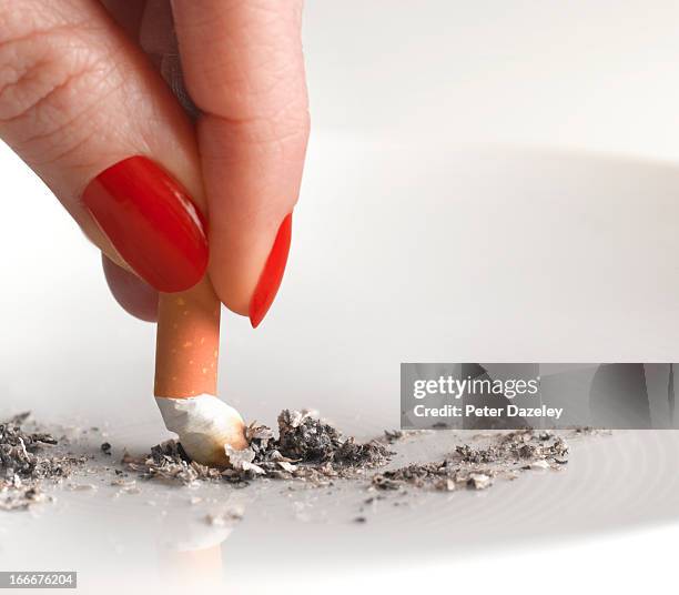 woman stubbing out cigarette - ashtray stock pictures, royalty-free photos & images