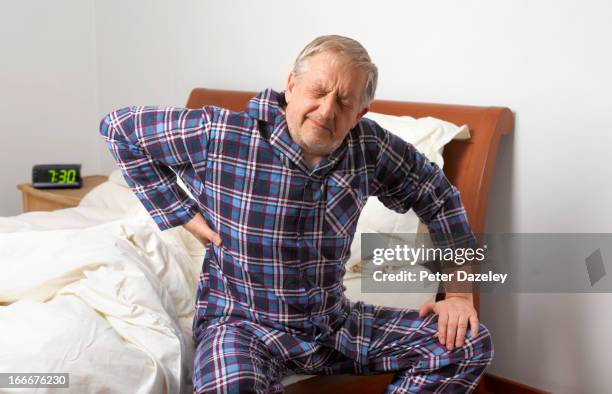 mature man with bad back - stijf stockfoto's en -beelden