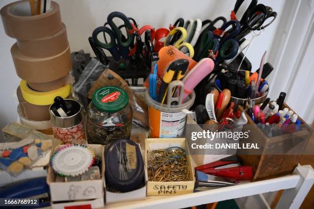 Scissors, pens and sewing needles are seen in the studio of fashion designer Phoebe English in Deptford, south of London, on September 1, 2023....