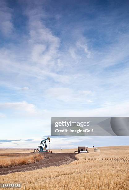 prairie pumpjack on the plains near calgary alberta - lethbridge alberta stock pictures, royalty-free photos & images