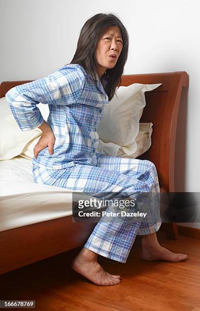 woman with back ache - back pain bed stock pictures, royalty-free photos & images