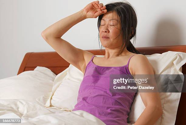 woman having night sweats - sleeping woman stock pictures, royalty-free photos & images