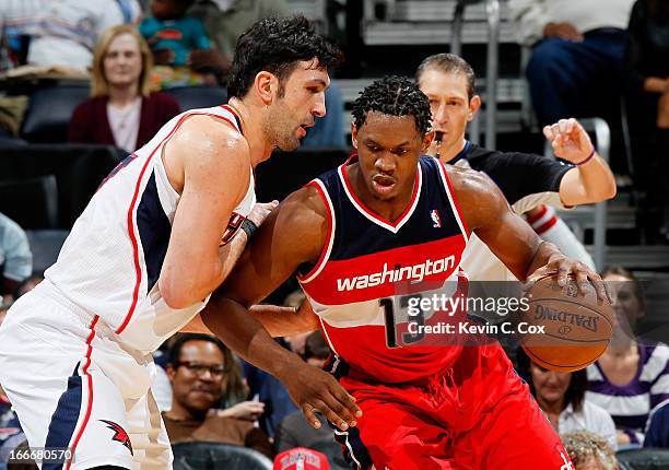 Kevin Seraphin of the Washington Wizards against Zaza Pachulia of the Atlanta Hawks at Philips Arena on December 7, 2012 in Atlanta, Georgia. NOTE TO...