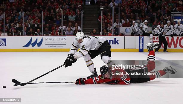 Brandon Saad of the Chicago Blackhawks hits the ice trying to get off a shot against Brenden Dillon of the Dallas Stars at the United Center on April...
