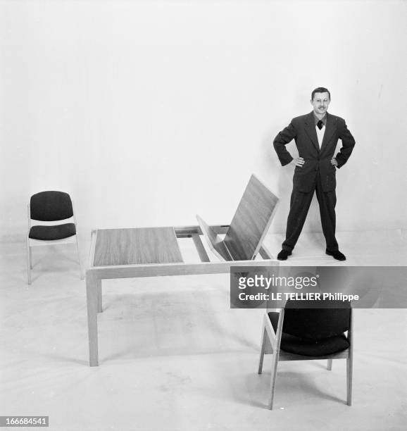 Ancient And Modern Furniture In The Fifties. En 1955, en studio sur fond neutre, un homme debout les mains sur la taille, présente un ensemble de...