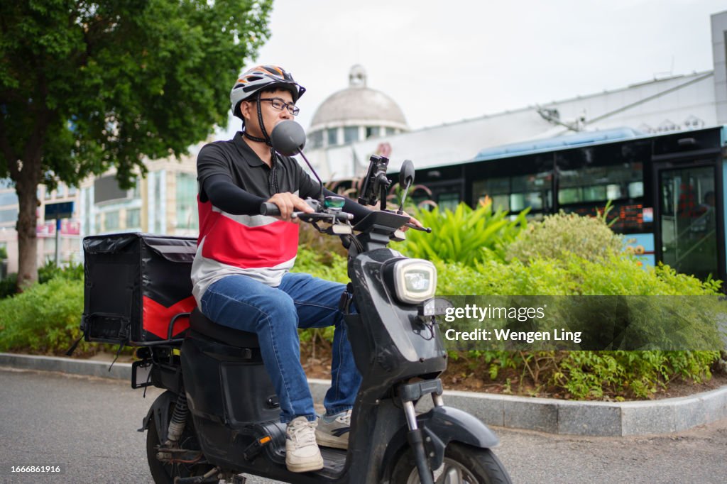 Food Rider Man Food Delivery Man Riding An Electric Bicycle High-Res Stock Photo ...
