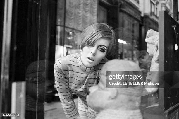 Op Art Make-Up In London. A Londres, dans un passage couvert, le modèle Kari-Ann, les yeux entourés d'un maquillage 'Op Art' et portant une robe col...
