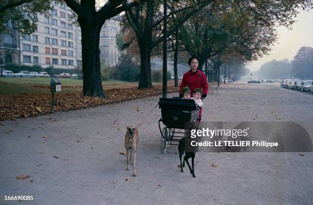 Close-Up Of Genevieve Page. Paris - 10 octobre 1963 - Sur une avenue du XVIe arrondissement, Geneviève PAGE portant un manteau rouge et un bonnet...