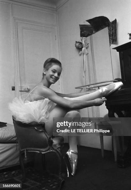 Rendezvous With The Belmondo Family. Attitude de la danseuse Muriel BELMONDO en tutu, laçant ses chaussons de danse. Février 1962.