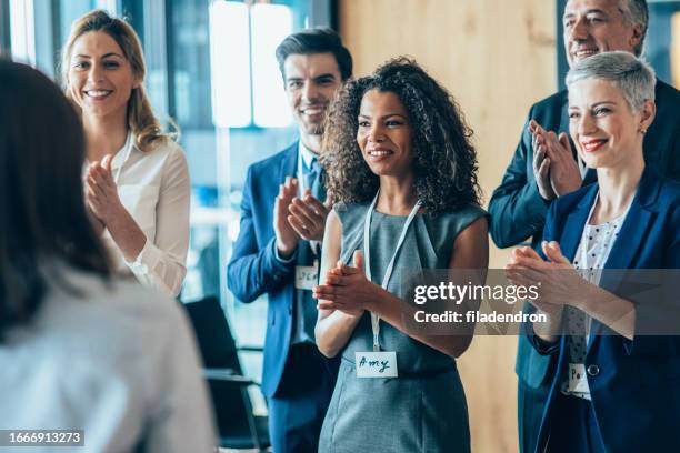 business people applauding during a seminar - applauding leader stock pictures, royalty-free photos & images