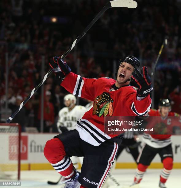 Niklas Hjalmarsson of the Chicago Blackhawks celebrates his 3rd period goal against the Dallas Stars at the United Center on April 15, 2013 in...