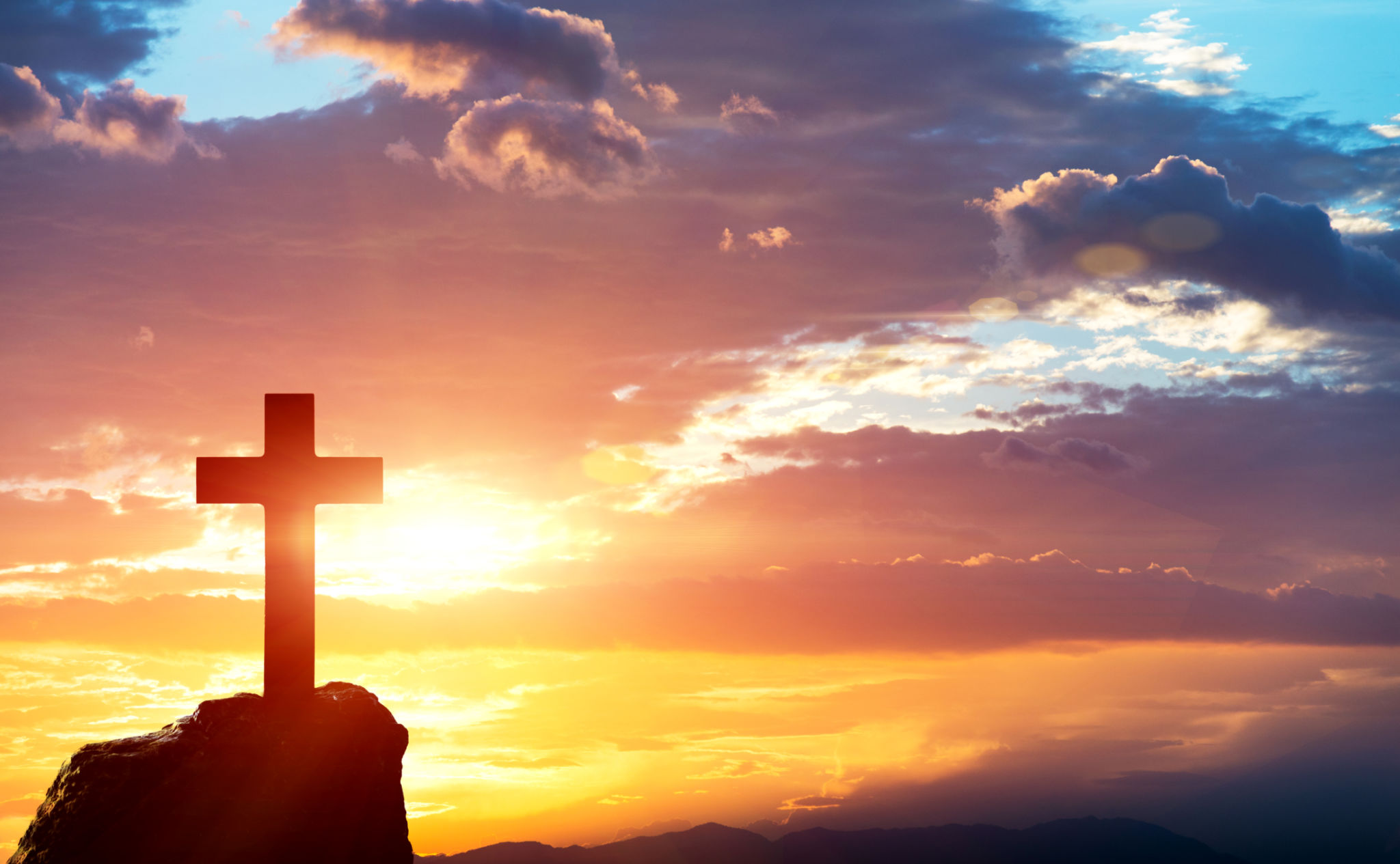 Religious cross on the hill at sunset Religious cross on the hill at sunset