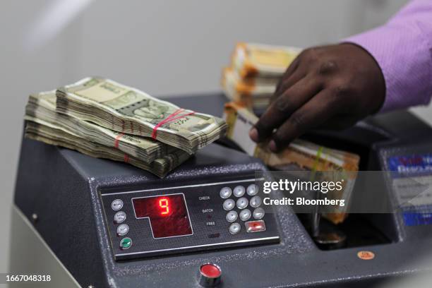 Bank Ltd. Teller counts Indian 200 rupee banknotes at the company's bank branch in Mumbai, India, on Tuesday, Sept. 12, 2023. HDFC Bank wants to use...