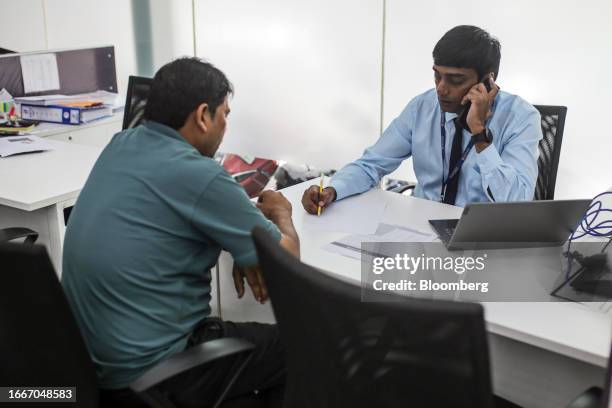 An employee attends a customer at a HDFC Bank Ltd. Bank branch in Mumbai, India, on Tuesday, Sept. 12, 2023. HDFC Bank wants to use home lending as a...