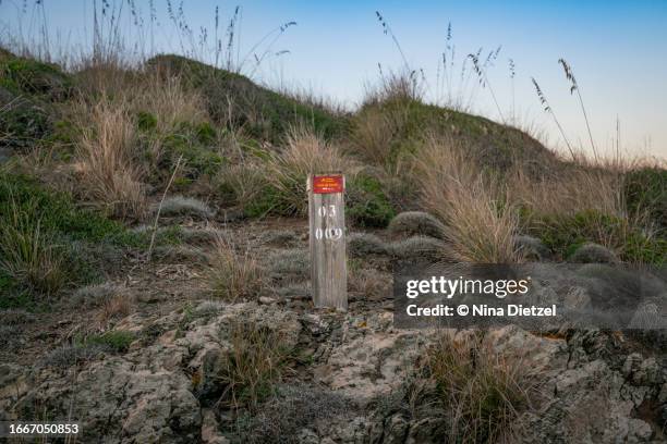 stage 3 marker of the cami de cavalls coastal trail on minorca - cavalls stock pictures, royalty-free photos & images
