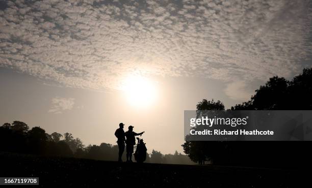 Tyrrell Hatton of England and his caddie Mick Donaghy wait to play a shot on the 11th hole during Day Two of the Horizon Irish Open at The K Club on...