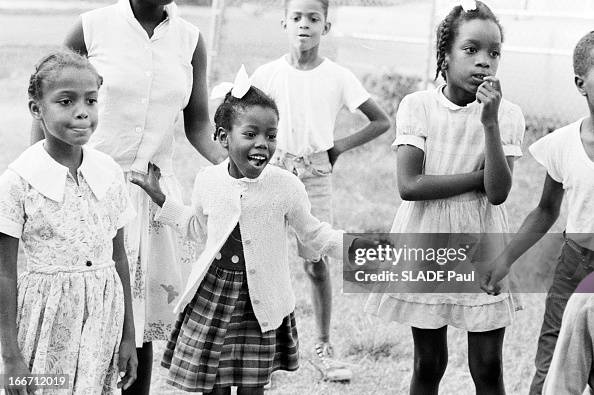 Ruby Bridges, 6 years old, wearing white cardigan and hair bow, plays ...