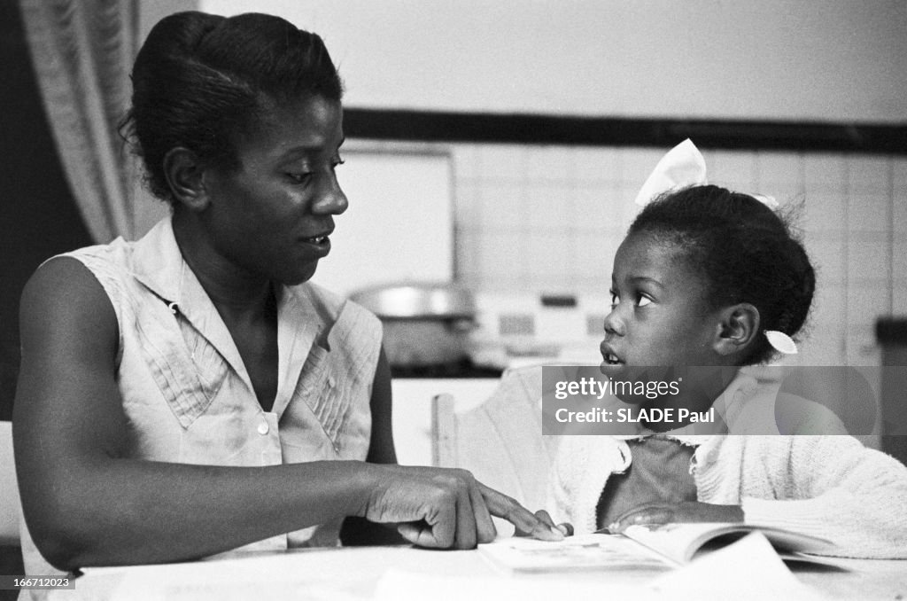 Lucille Bridges and her daughter Ruby Bridges, 6 years old, seated