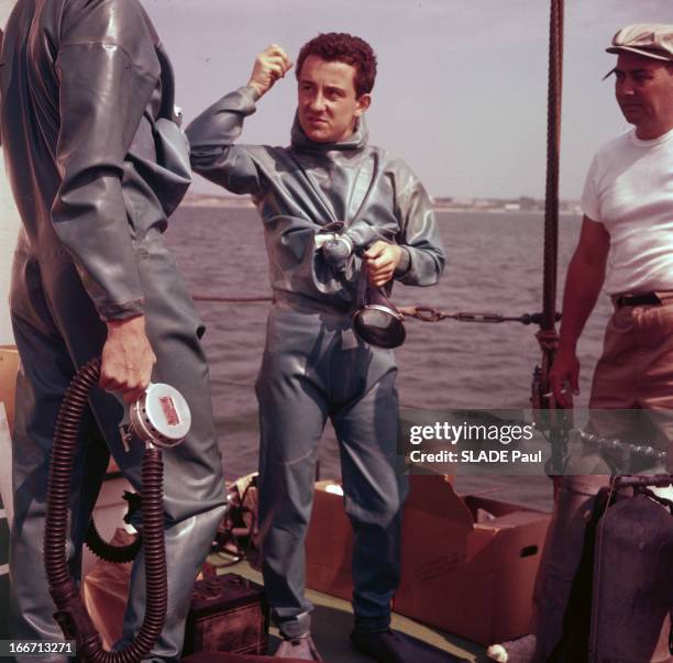 Louis Malle. En 1956, sur un bateau en mer, Louis MALLE, avec une combinaison de plongée, tenant un masque, en compagnie d'un autre plongeur, en...