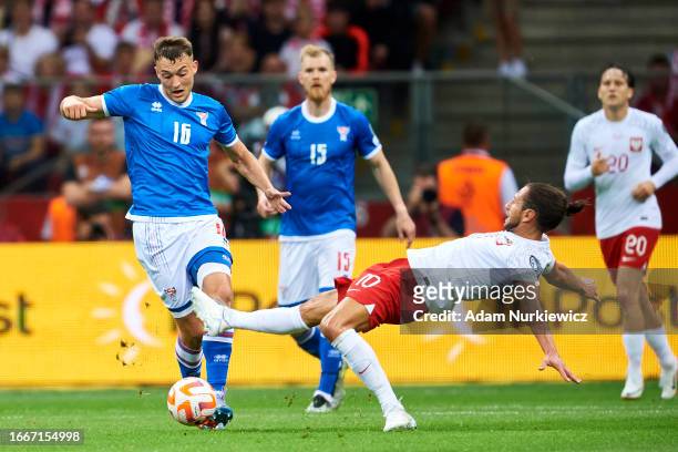 Gunnar Vatnhamar from Faroe Islands fights for the ball with Grzegorz Krychowiak from Poland during the UEFA 2024 European Qualifiers group E match...