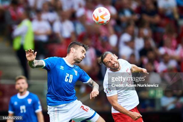 Grzegorz Krychowiak from Poland fights for the ball with Rene Joensen from Faroe Islands during the UEFA 2024 European Qualifiers group E match...