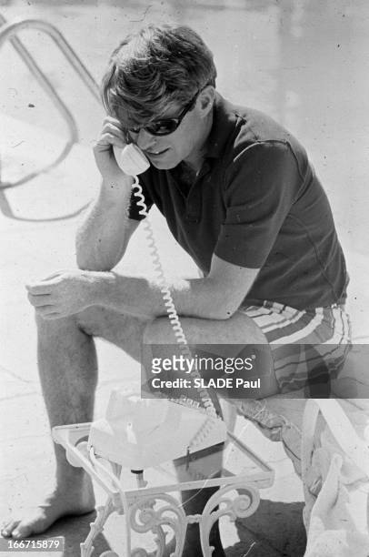 United States Attorney General Robert F. Kennedy during a poolside phone call at Hickory Hill, his house in McLean, Virginia, 17th April 1964....