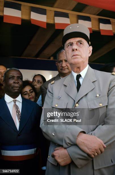Official Travel Of General Charles De Gaulle To The Caribbean And Guyanne. Aux Antilles, en extérieur, sous un préau décoré de fanions tricolores, le...