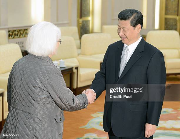 Iceland's Prime Minister Johanna Sigurdardottir shakes hands with Chinese President Xi Jinping during a meeting at the Great Hall of the People on...