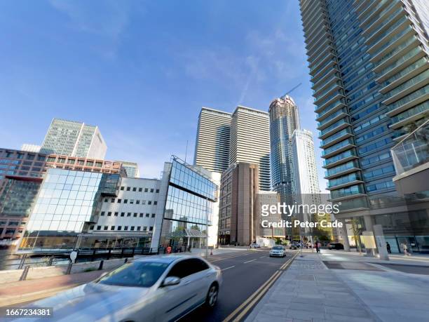 car driving through canary wharf london - a blue car driving in speed stock pictures, royalty-free photos & images