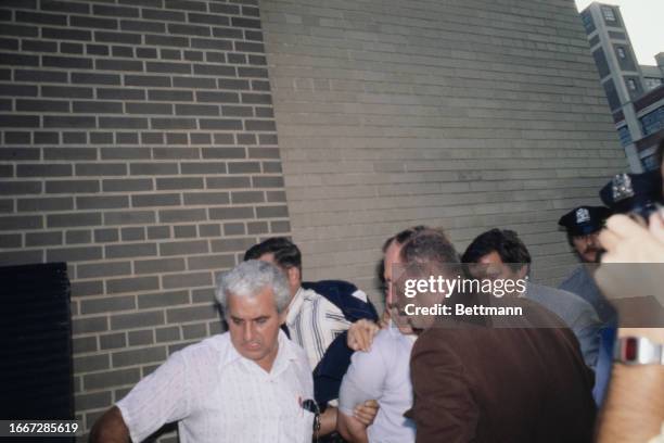 Serial killer David Berkowitz, also known as 'Son of Sam', is brought into 84th precinct in Brooklyn, New York, for booking, August 11th 1977. The...