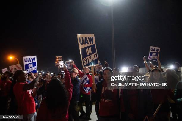 Members of the UAW picket and hold signs outside of the UAW Local 900 headquarters across the street from the Ford Assembly Plant in Wayne, Michigan...