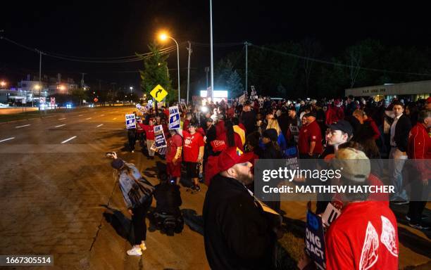 Members of the UAW picket and hold signs outside of the UAW Local 900 headquarters across the street from the Ford Assembly Plant in Wayne, Michigan...