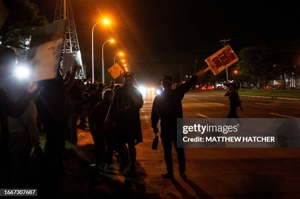 Members of the UAW picket and hold signs outside of the UAW Local 900 headquarters across the street from the Ford Assembly Plant in Wayne, Michigan...