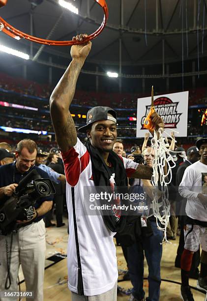 Injured guard Kevin Ware of the Louisville Cardinals celebrates after he cut down the net against the Michigan Wolverines during the 2013 NCAA Men's...